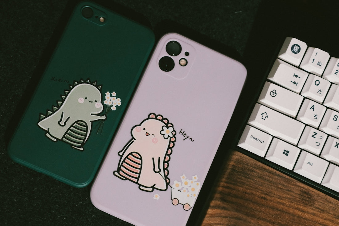 a couple of cell phones sitting next to a keyboard